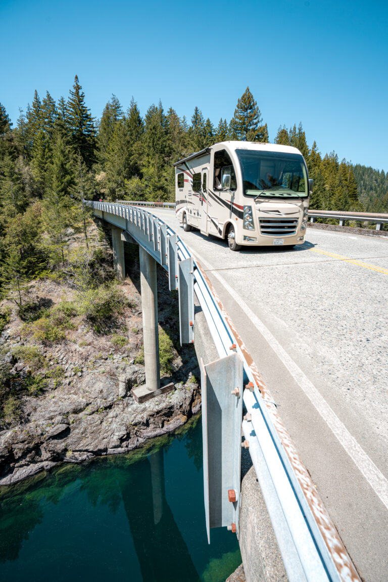 A Class A motorhome driving over a bridge