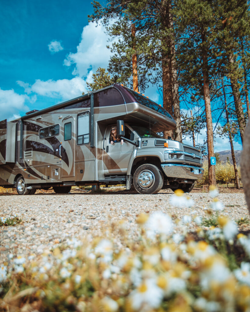 a woman in a Class C camper looking out the window