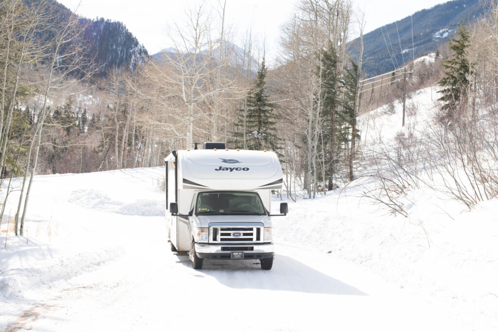 An RV driving in the snow