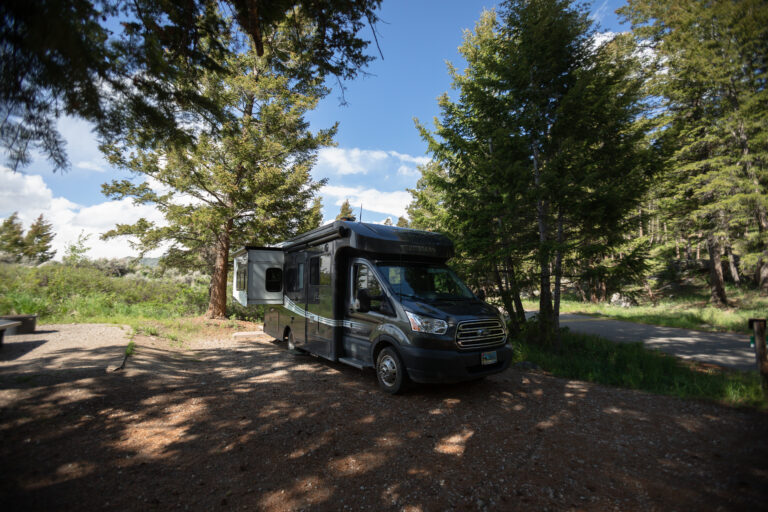 a Class C camper at a lake campground