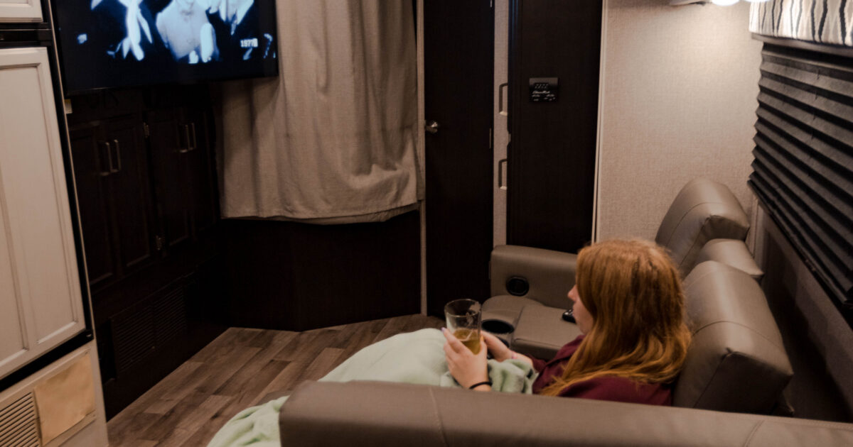 A woman watching TV in an RV