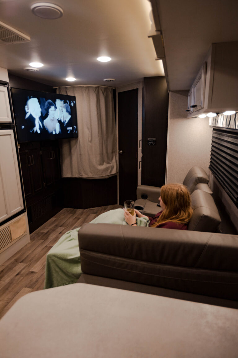 A woman watching TV in an RV