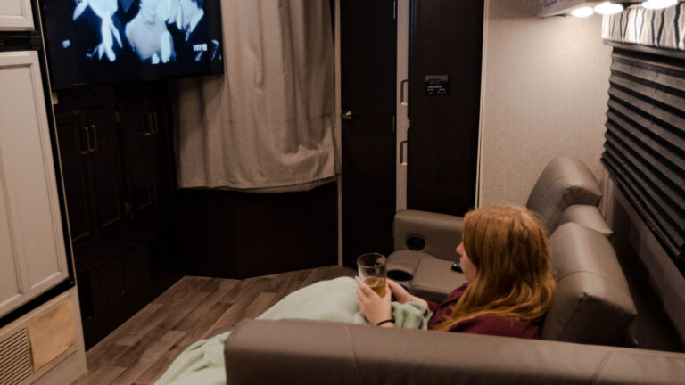 A woman watching TV in an RV