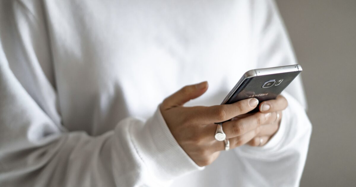 Person using RV apps on their phone