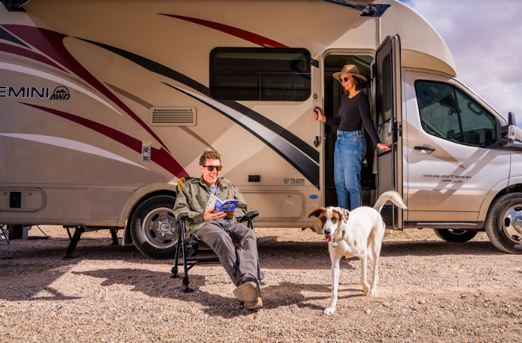 a woman standing in doorway of a Class C RV