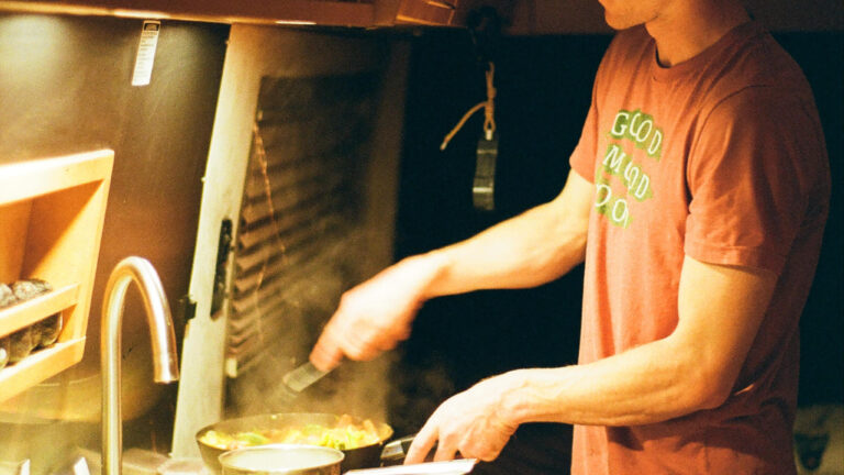 a man cooking on an RV stove