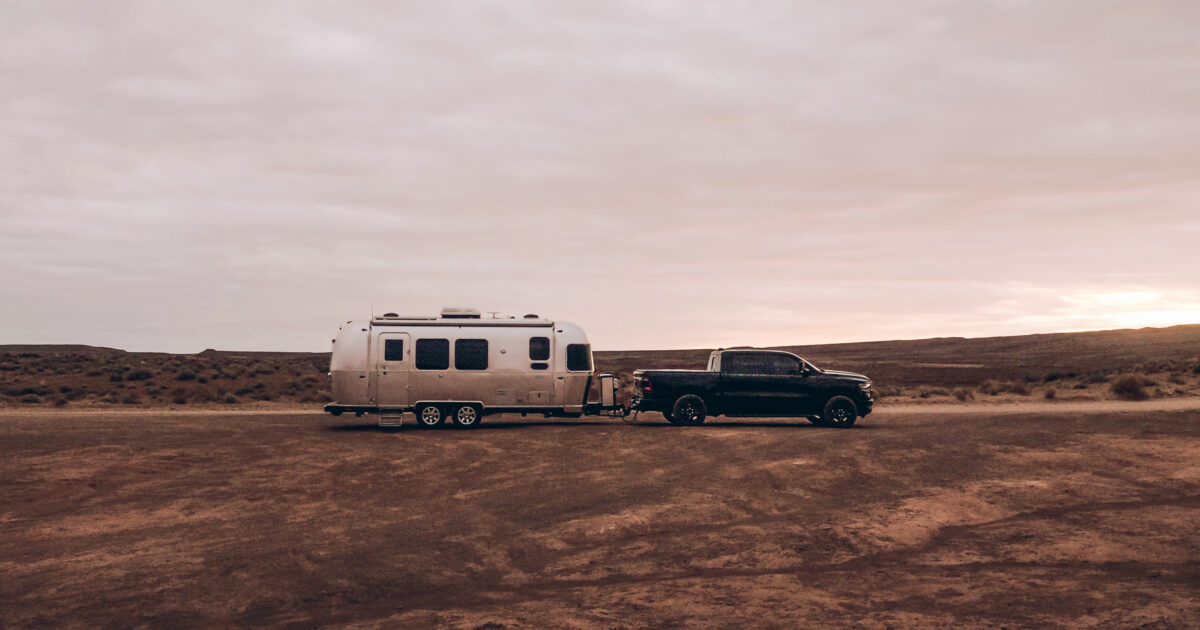 a pickup towing an airstream trailer