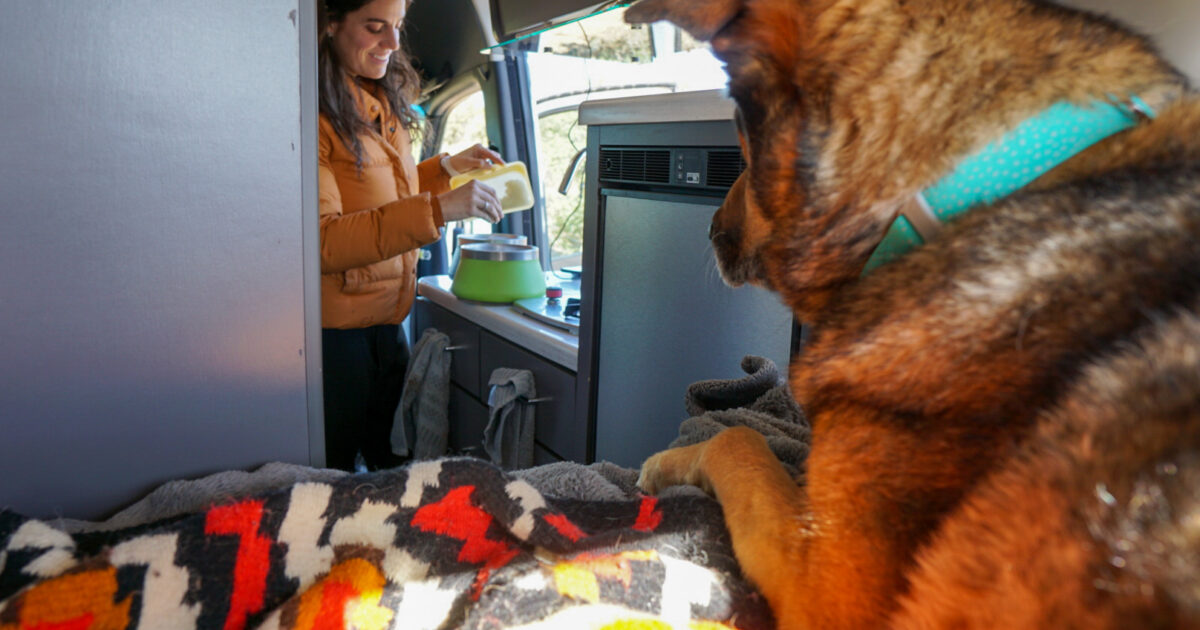 a woman cooking in an campervan