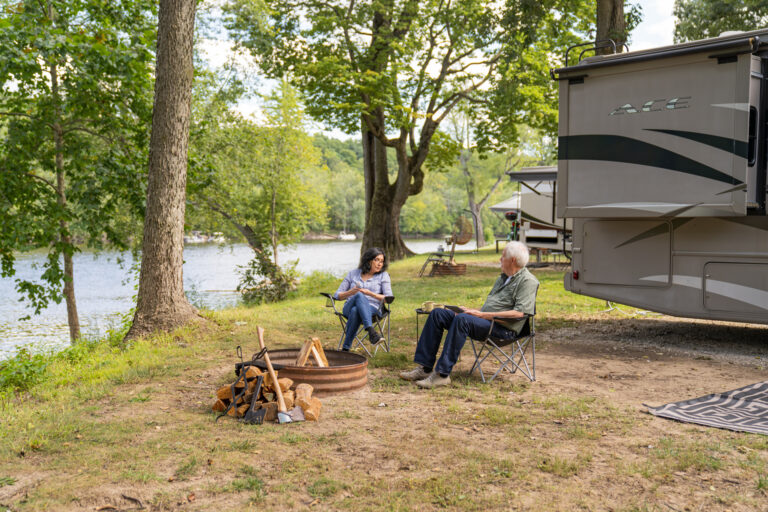 an older couple next to their RV