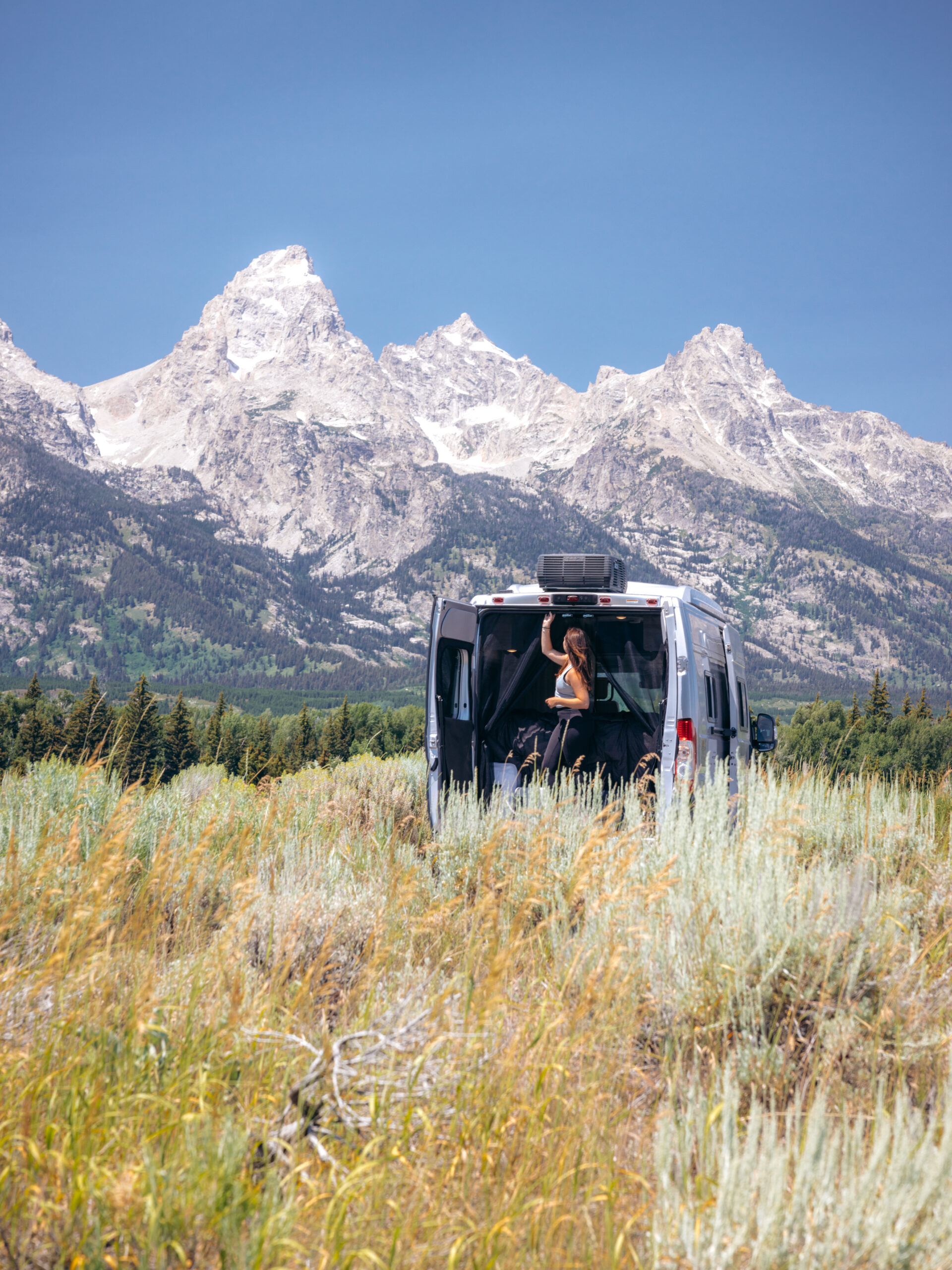 A Class B camper in front of mountains