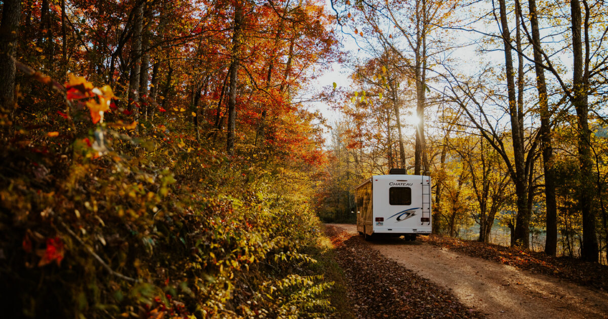 an RV driving down a dirt lane