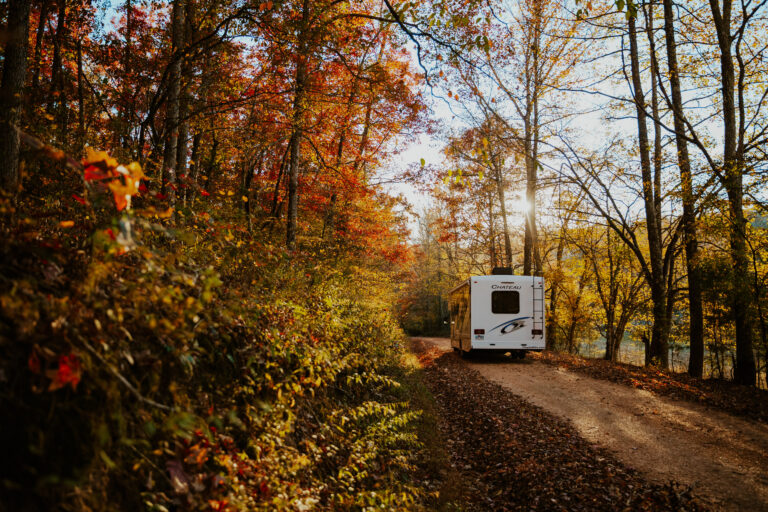 an RV driving down a dirt lane