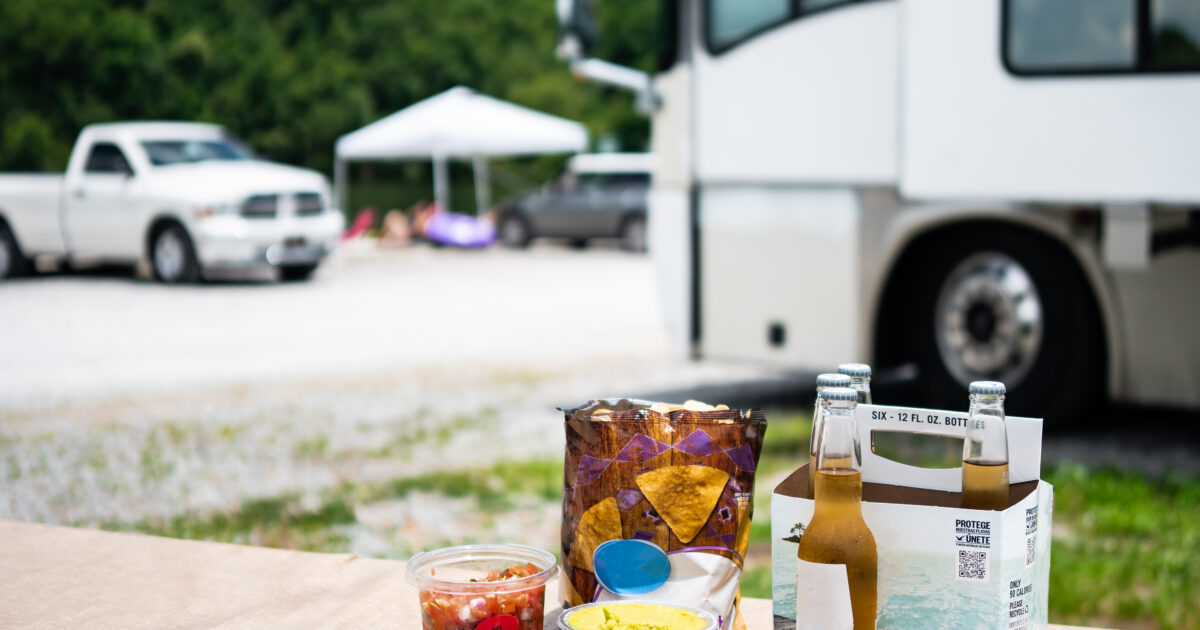 an RV next to a picnic table