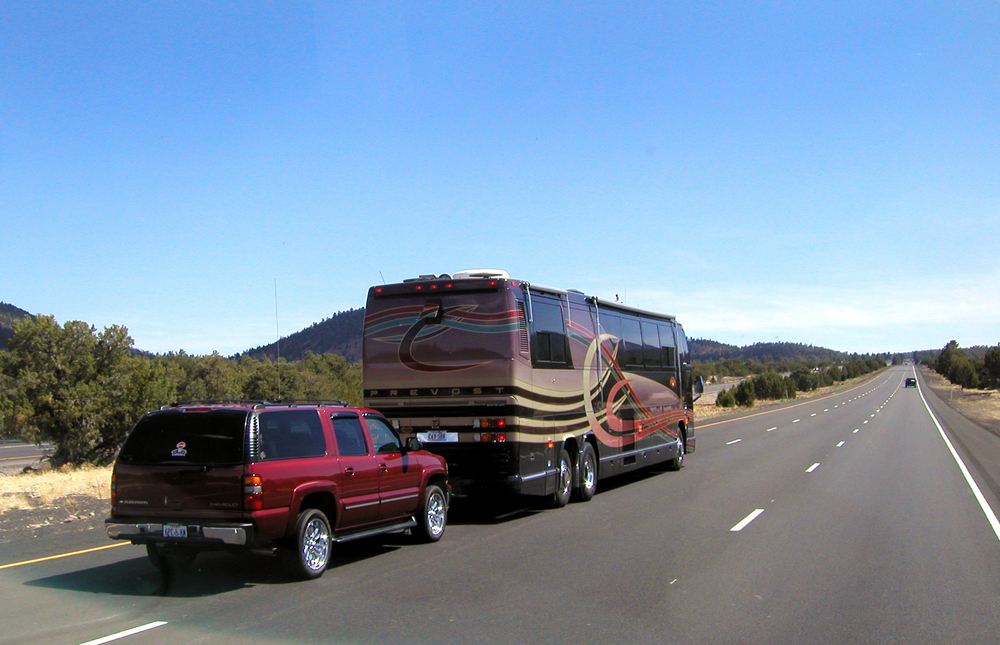 an RV towing a car