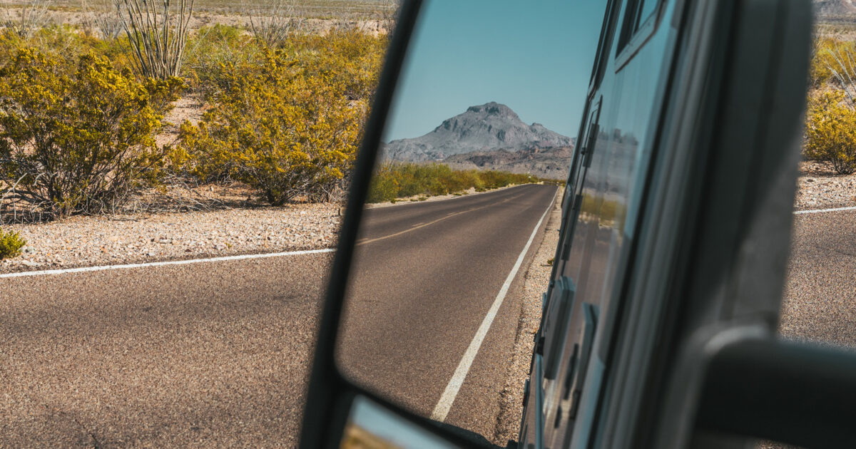 looking in an RV mirror at the road
