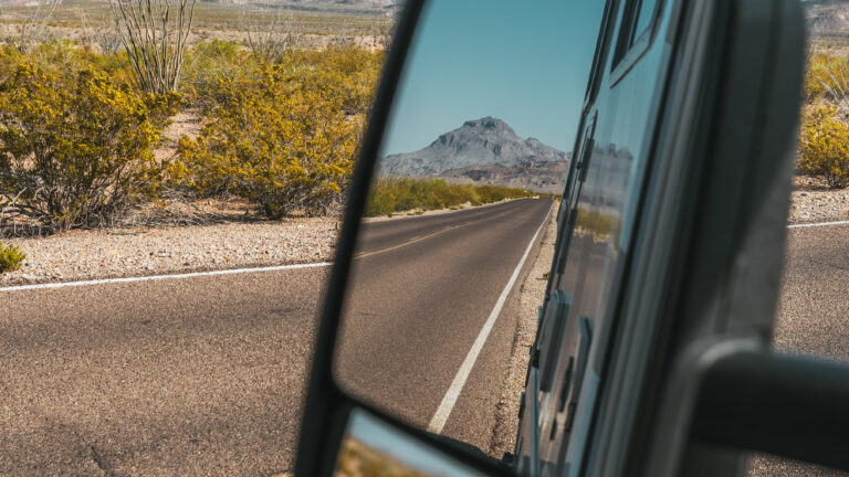 looking in an RV mirror at the road