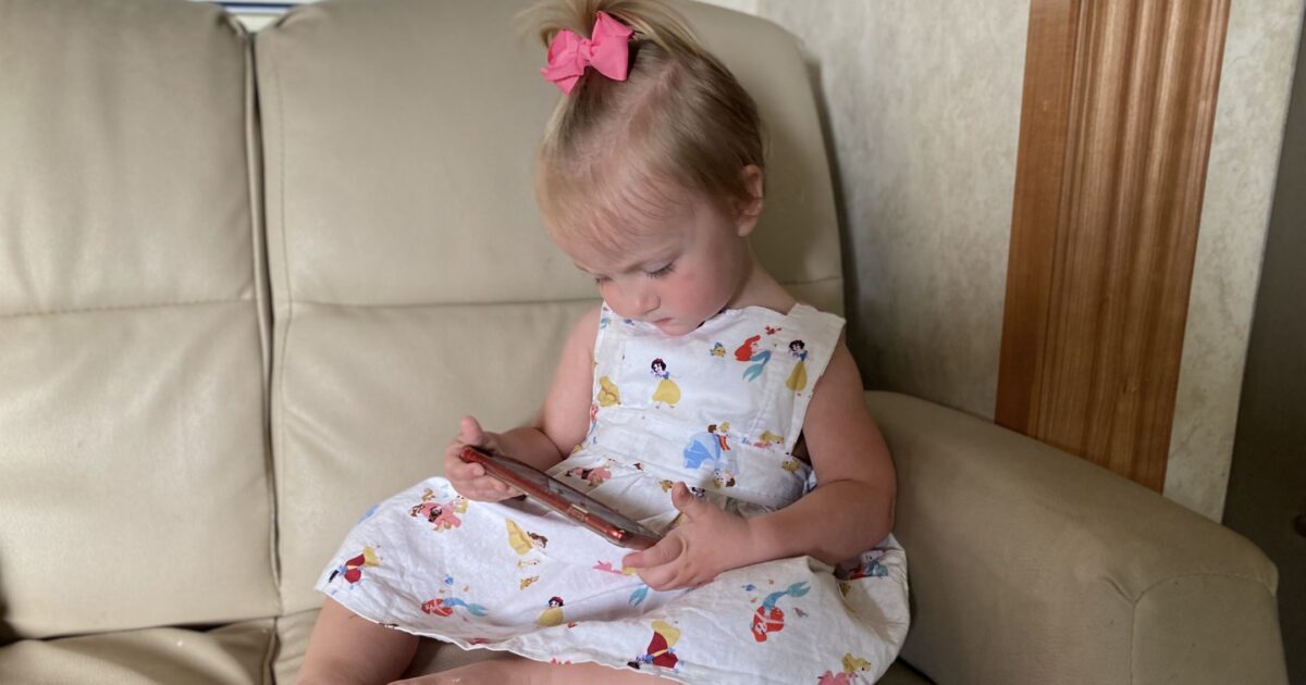 Little girl sitting on RV couch