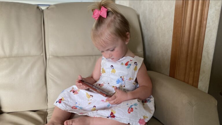 Little girl sitting on RV couch