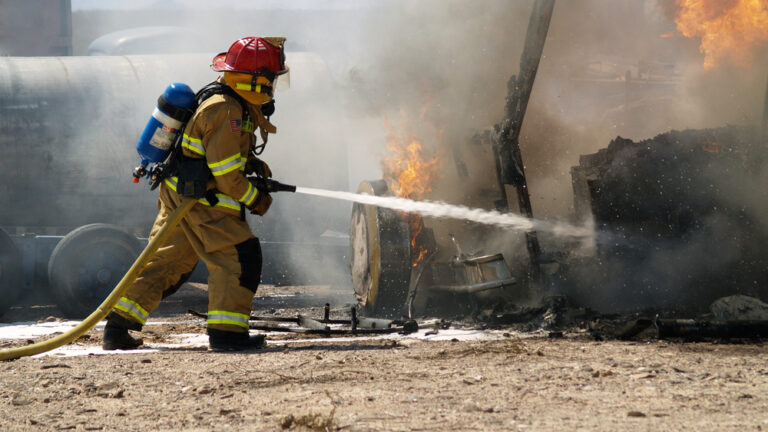 a fireman putting out an RV fire