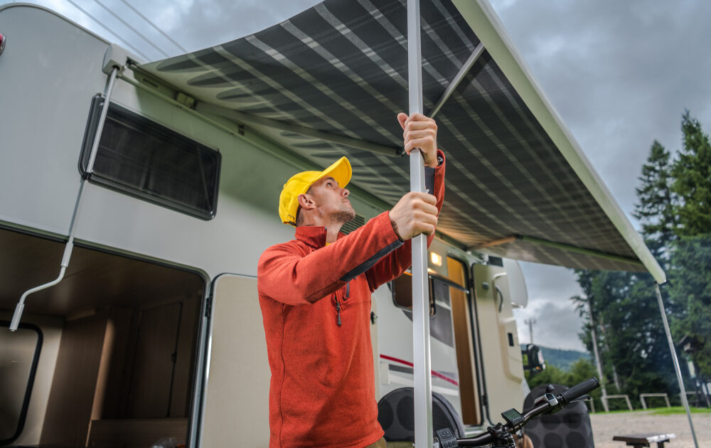 a man setting up an RV awning