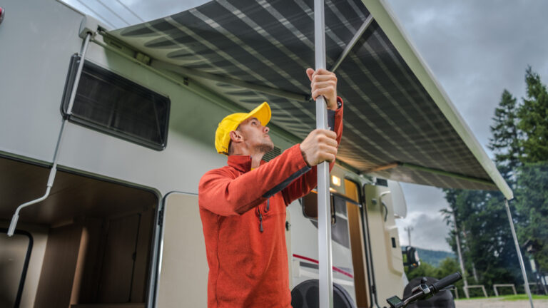 a man setting up an RV awning