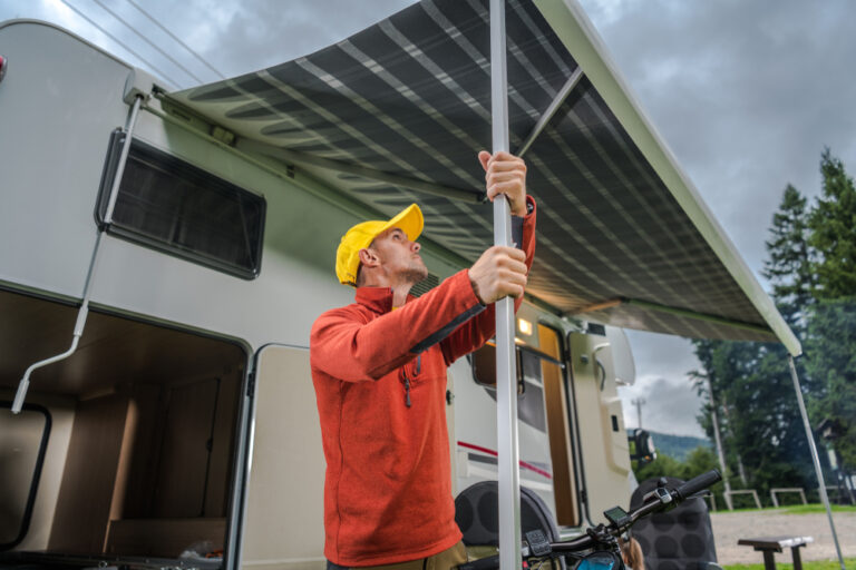 a man setting up an RV awning