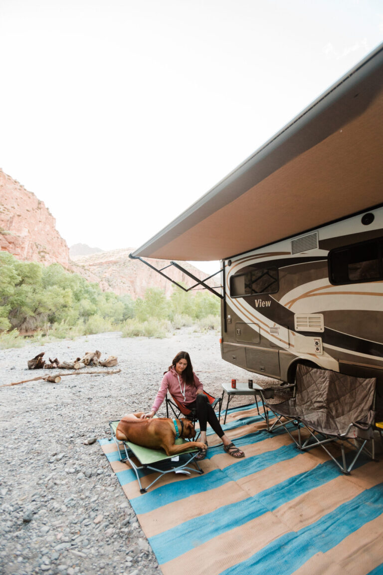 a woman relaxing under an RV awning