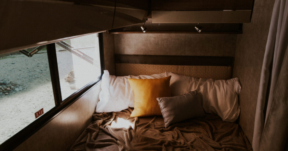 an RV bed with trendy bedding