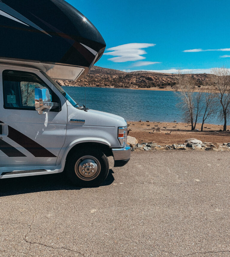 an RV parked by a lake