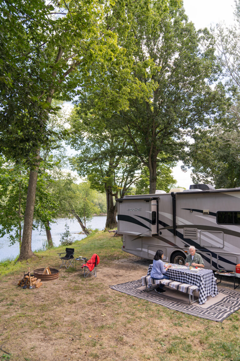 an older couple eating near their RV