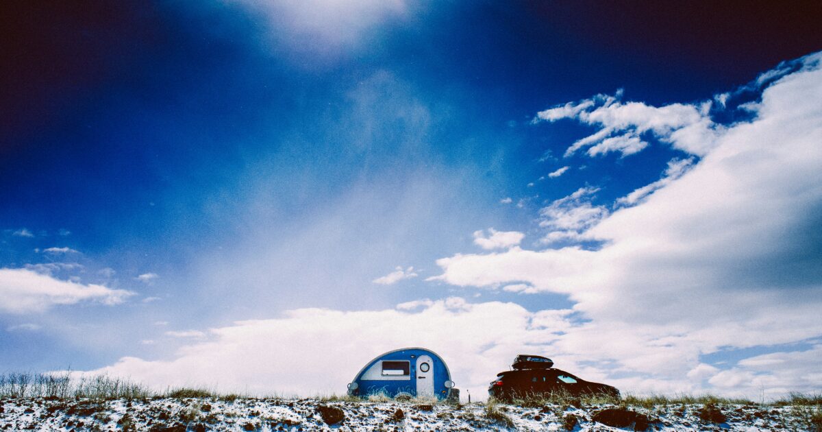 blue teardrop camper in the snow