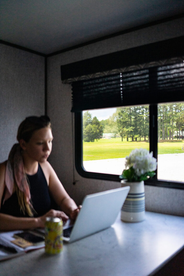 woman in RV working at computer