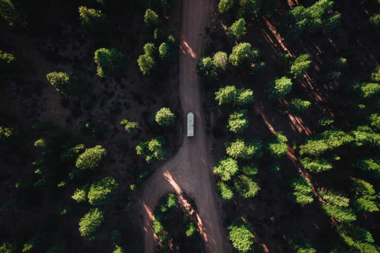 An aerial view of an RV driving down a road