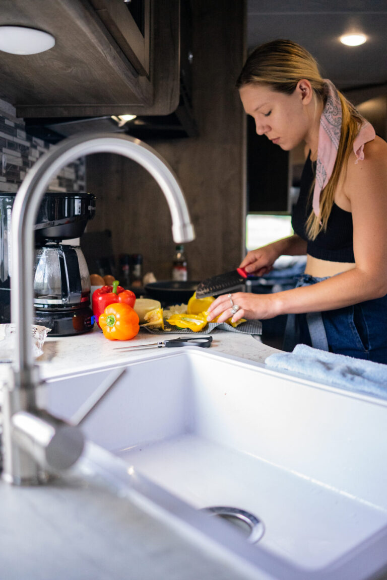 a woman prepping food in an RV