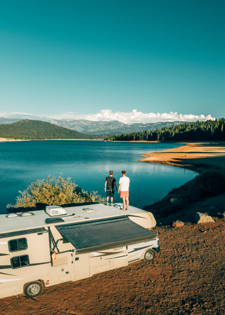 an RV parked next to a lake