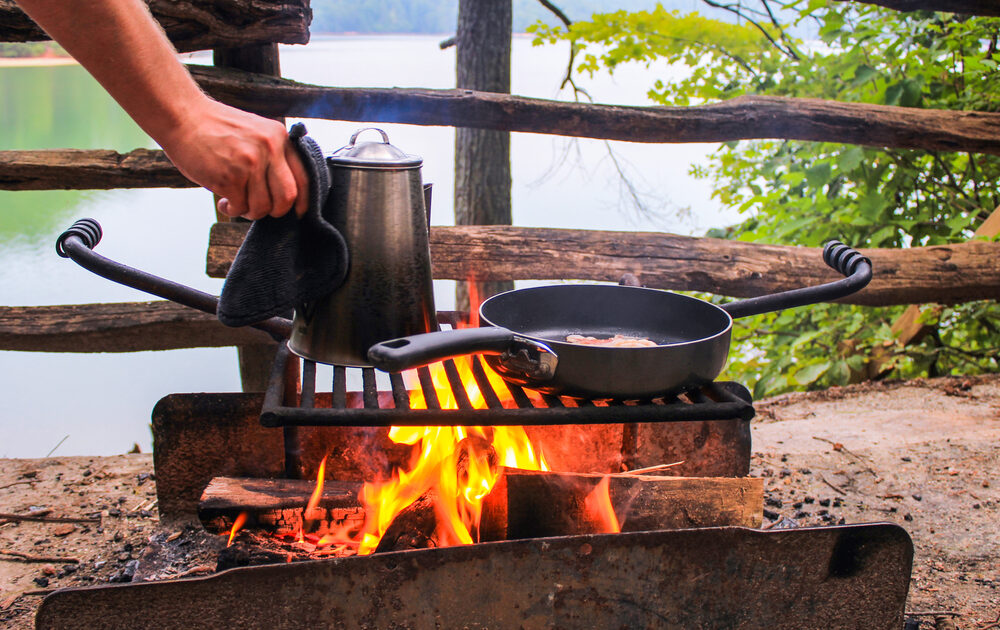 a campfire breakfast with coffee and eggs