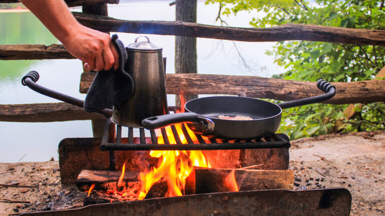 a campfire breakfast with coffee and eggs