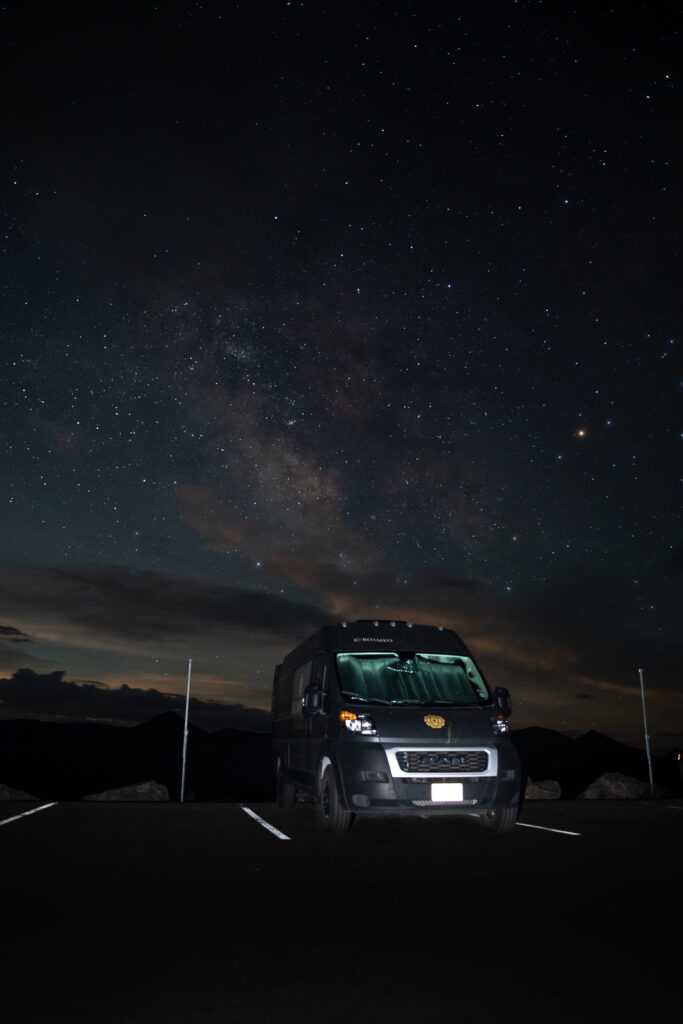 a campervan in a parking lot at night