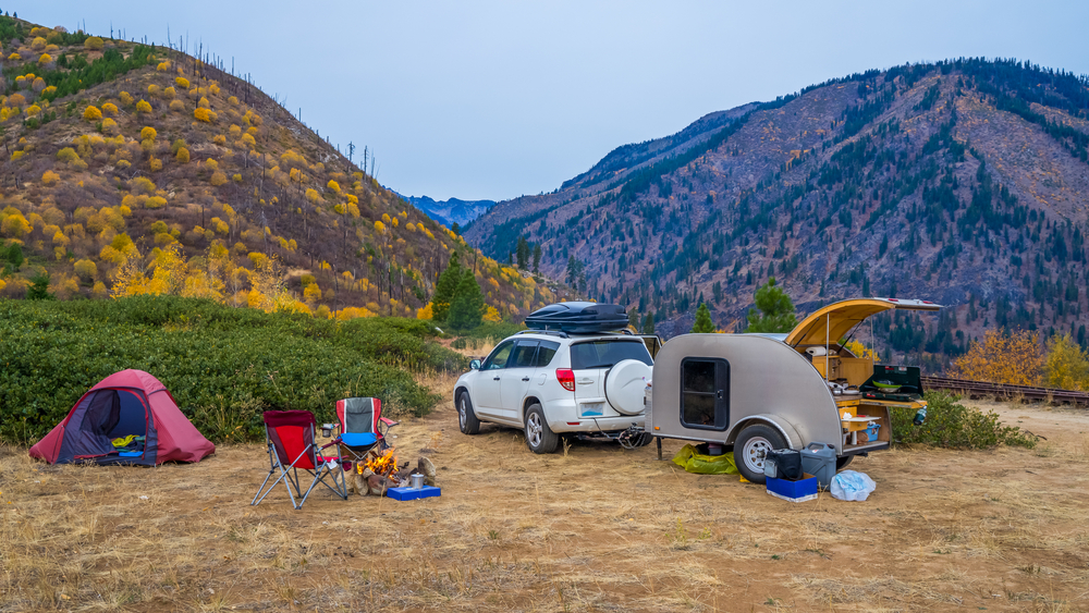 A teardop camper set up at a campsite