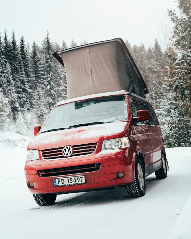 A red VW camper in the snow