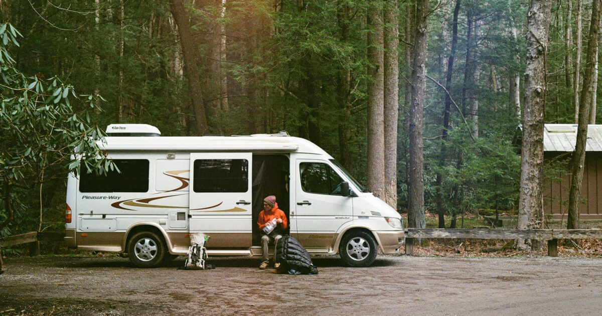 camper van parked in the middle of the woods