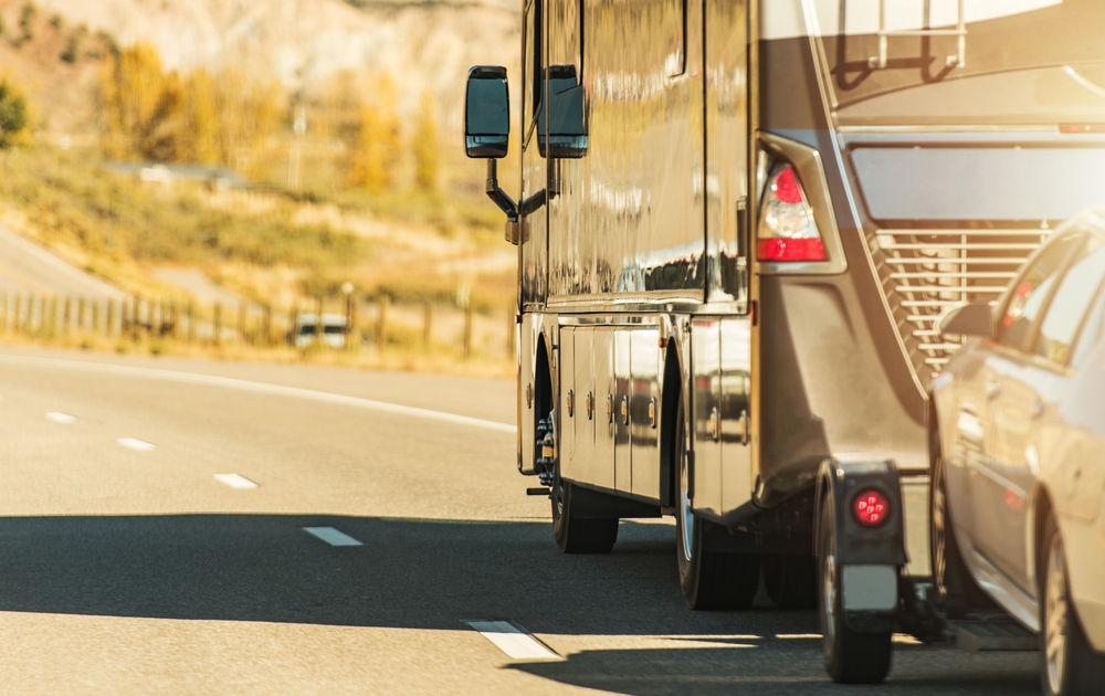 A Class A RV towing a car