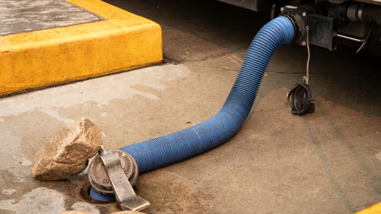 A hose stretching from RV holding tank to sewer