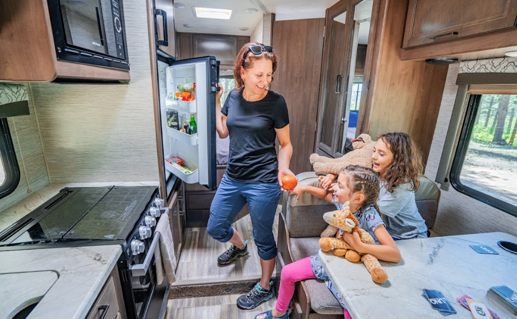 A mom opening an RV fridge