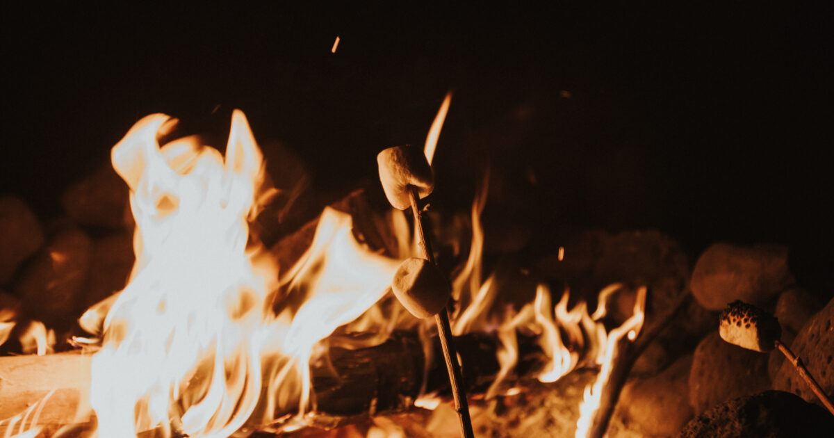 someone roasting smores over an open campfire