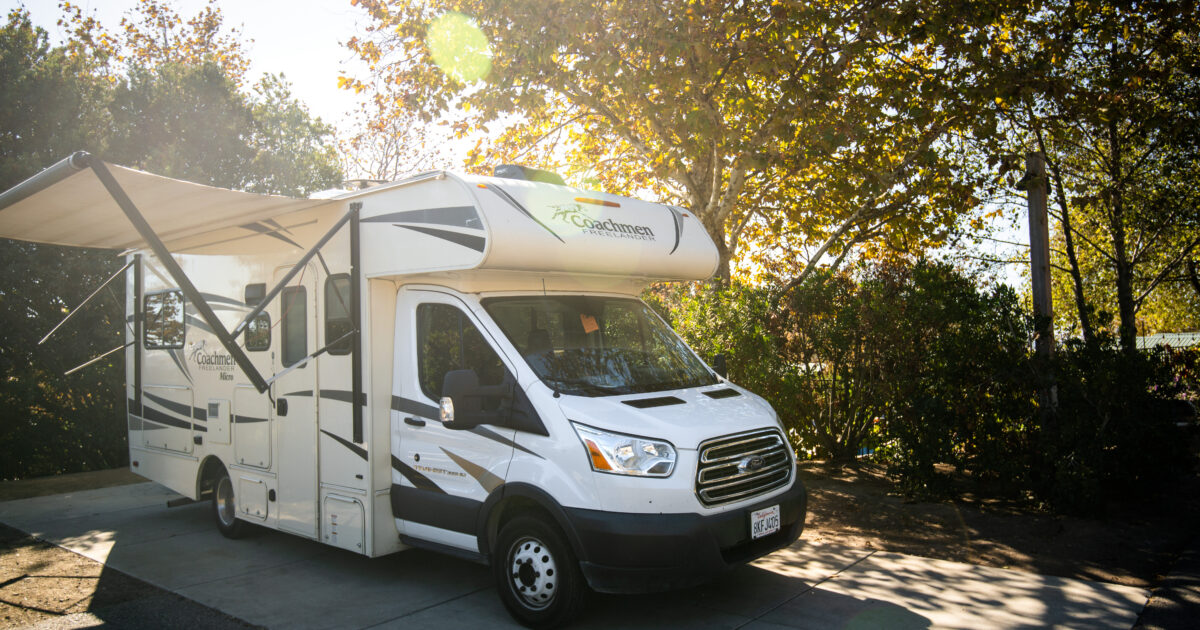 An RV set up with an awning open
