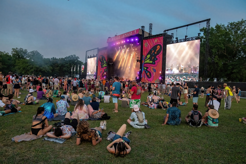 People sitting on the grass at the Bonnaroo Festival