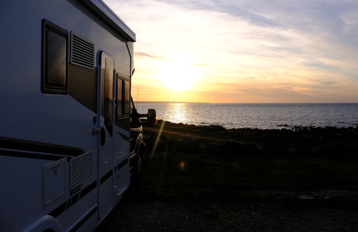 passenger RV side overlooking water at sunset