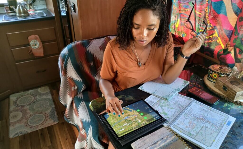 A woman with maps planning an RV trip