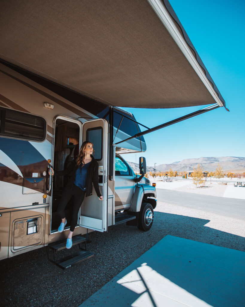 A woman standing in her RV doorway